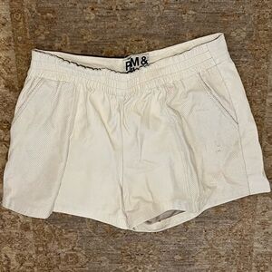 Cream leather shorts w/pockets. Elastic waste. Small stain/scratch but barely